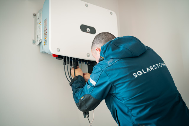 Solarstone electrician installing inverter