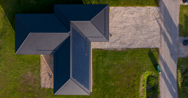 drone shot of a house with solar tiled roof