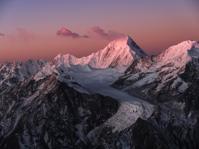 an image of snowy mountains in sunset