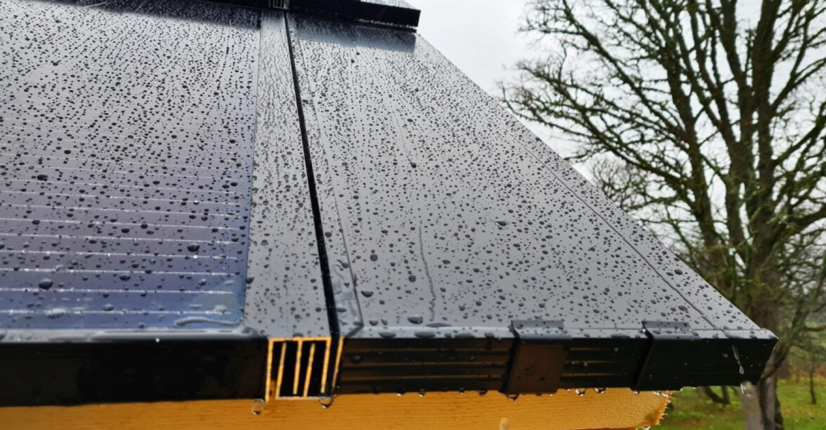 close up of solarstone solar full roof and click-on framing in rainy weather