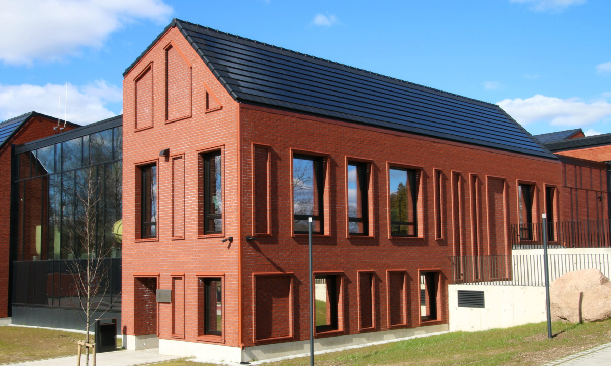 red brick building with solar tiled roof panels