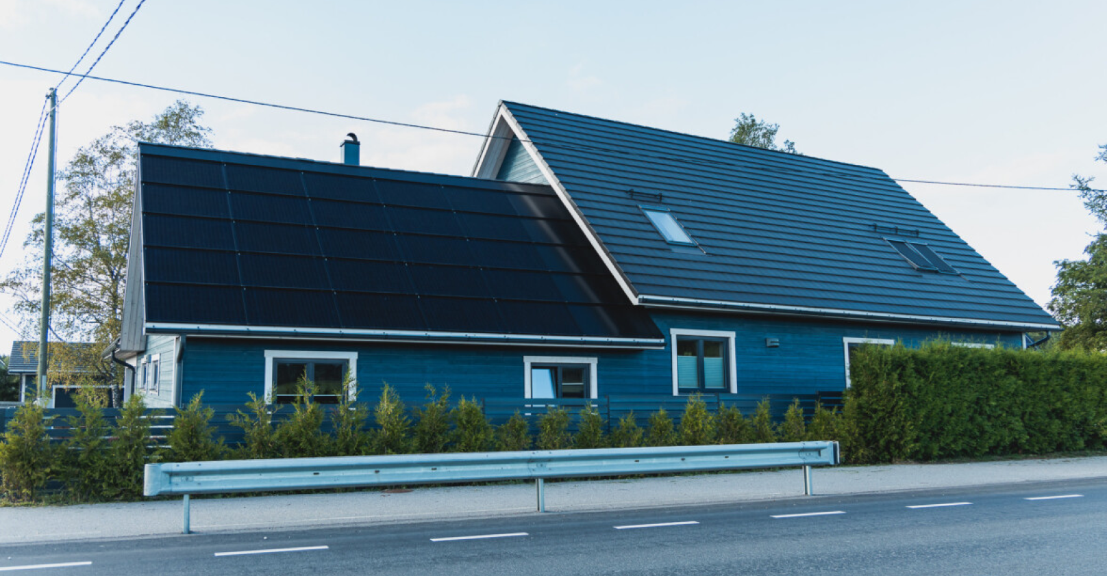 blue house with solar full roof and roof tiles