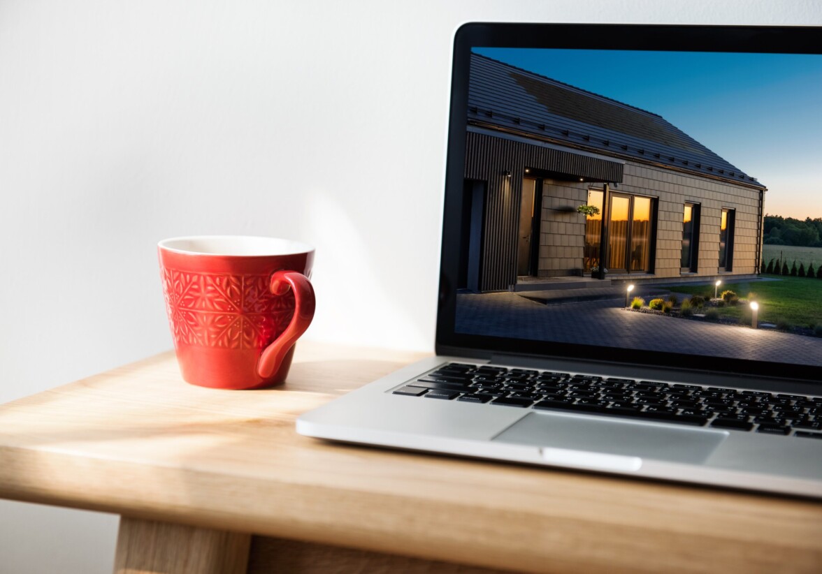 laptop and coffee mug with solar roof on the screen