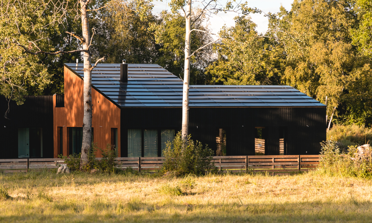 solarstone solar full roof solar panels on a brown one-sloped house